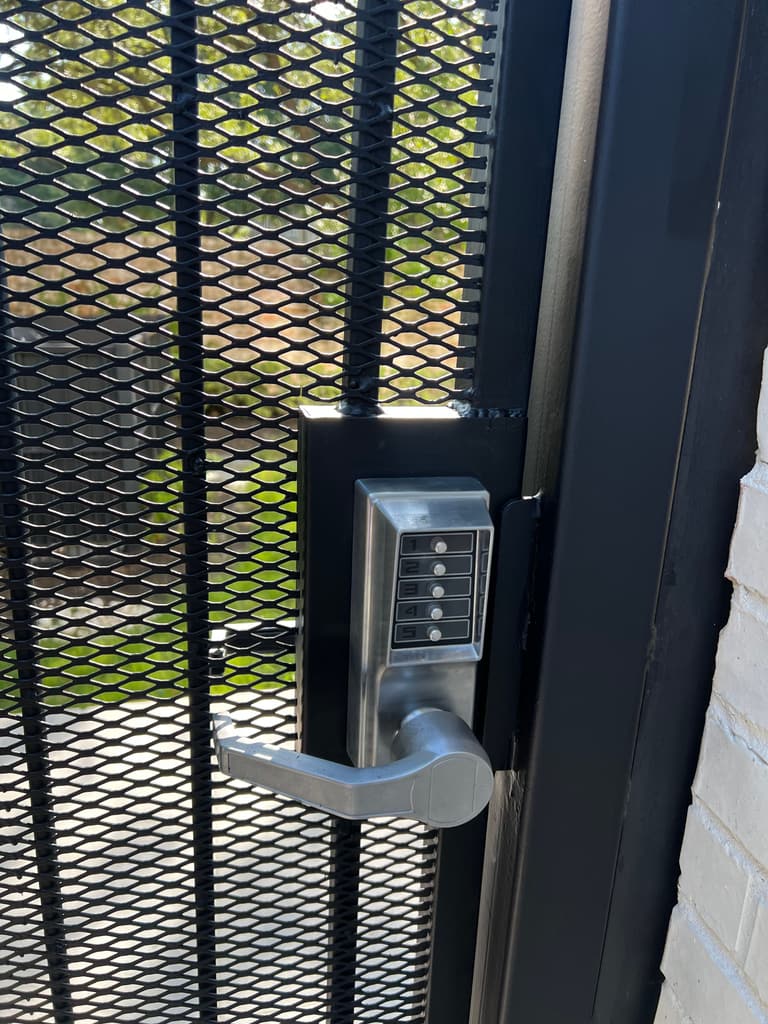 Finished mesh security gate with a rebuilt black lock box and keypad lock
