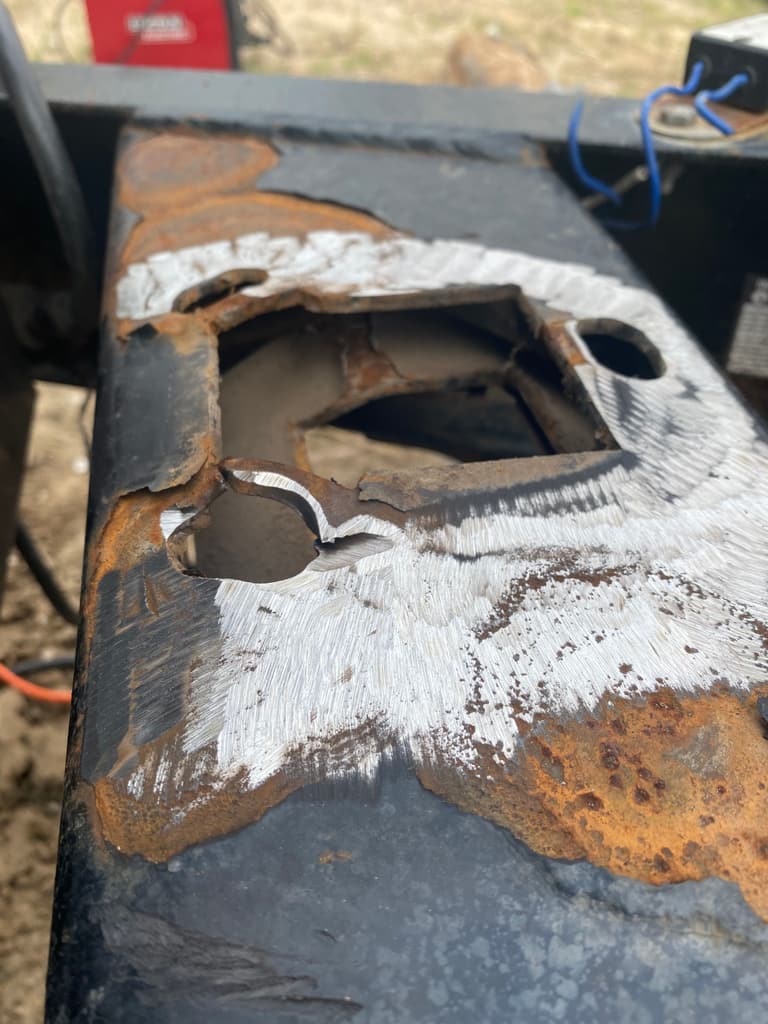 Trailer tongue plate rusted through around the jack mount, ground back to bright steel around the hole